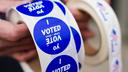 A poll worker holds voting stickers for community members Nov. 7, 2023, at Central Elementary School in Allentown, Lehigh County, Pennsylvania. A poll worker holds voting stickers for community members Nov. 7, 2023, at Central Elementary School in Allentown, Lehigh County, Pennsylvania.