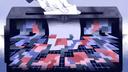 Illustration of a hand inserting a white ballot into a dark ballot box filled with colorful geometric shapes. Illustration of a hand inserting a white ballot into a dark ballot box filled with colorful geometric shapes.