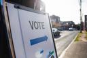 A sign showing people where they should cast their ballots for an election. A sign showing people where they should cast their ballots for an election.