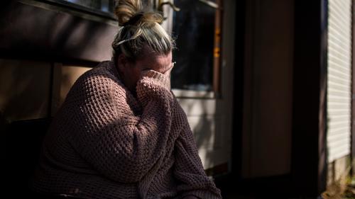 Laura Gallagher, of Langhorne, Pa., tears up in front of her home due to the fear of being evicted with nowhere to go on Wednesday, Oct. 14, 2020.