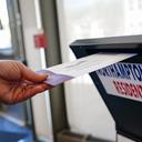 A voter puts a ballot into a drop box on primary Election Day 2024 at Bethlehem City Hall in Northampton County, PA.