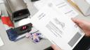 A worker time-stamps a mail ballot in Chester County.