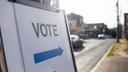 A sign directing voters to the entrance of a polling area.