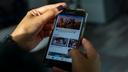 Jesenia De Moya Correa scrolls through Facebook on her phone while at work at the Philadelphia Media Network office on Monday, Nov. 19, 2018. 