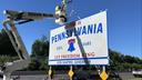 A Pennsylvania highway sign with new branding matching that of the commonwealth's new contested license plate.