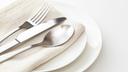 A stock image of a plate, silverware, and napkin. A stock image of a plate, silverware, and napkin.