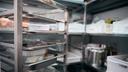 A stock image of a walk-in fridge in a restaurant. A stock image of a walk-in fridge in a restaurant.