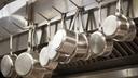 A stock image of pans hanging in a restaurant. A stock image of pans hanging in a restaurant.
