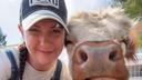 April Crossley with pet Highland cow April Crossley with pet Highland cow