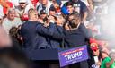 The Secret Service immediately surround former President Trump after he was shot during his campaign stop at the Butler Farm Show grounds on Saturday, July 13, 2024.