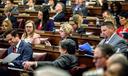 The state House on Monday passed temporary rules allowing members to vote remotely to party leaders, though those leaders will still be required to appear in person in the Capitol to formally consider legislation.