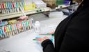 A pharmacy worker prepares a prescription.