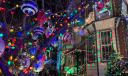 Rowhomes and trees are decked out in holiday lights and ornaments on this stretch of South 13th Street in Philadelphia.