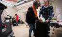 Three election workers put provisional ballots in the hopper at the 5th and 9th division of the 26th Ward after the polls closed at the polling place at Barry Recreation Center, in South Philadelphia, on Election Day.