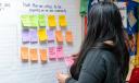 A woman in Berks county puts up a Post It note listing issues critical to her community