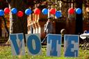 Students on the campus of the University of Pittsburgh walk past a ‘vote’ sign on Election Day, Nov. 5., 2024.