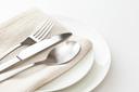 A stock image of a plate, silverware, and napkin. A stock image of a plate, silverware, and napkin.