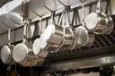 A stock image of pans hanging in a restaurant. A stock image of pans hanging in a restaurant.