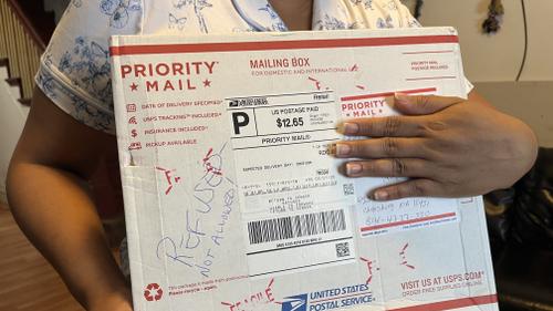 Wendys Martinez holds up the package containing her husband's replacement cane and hearing aids that she tried to send to him in ICE detention at Cambria County Prison. Wendys Martinez holds up the package containing her husband's replacement cane and hearing aids that she tried to send to him in ICE detention at Cambria County Prison.