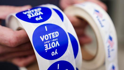 A poll worker holds voting stickers on Nov. 7, 2023. A poll worker holds voting stickers on Nov. 7, 2023.
