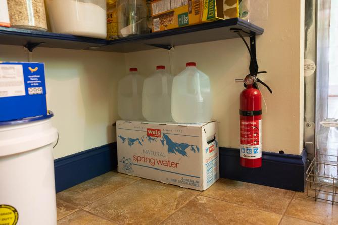 Bottled water stored in a pantry.
