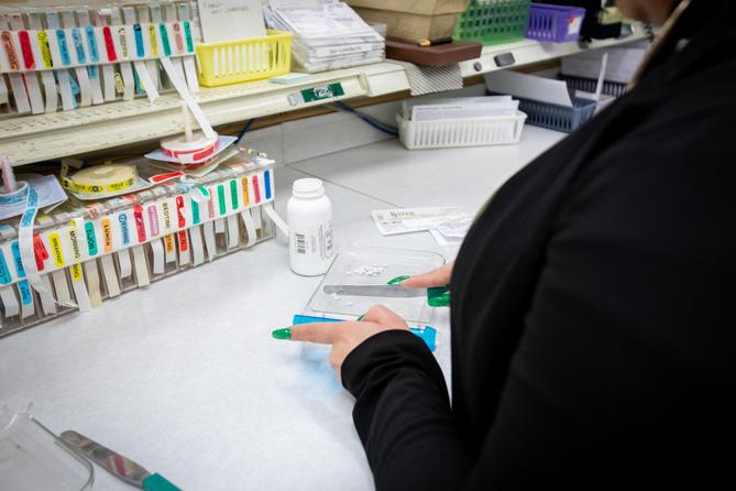 A pharmacy worker prepares a prescription.
