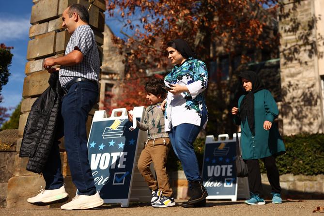 Voters walk past “Vote Here” signs at Temple Sinai in the Squirrel Hill neighborhood of Pittsburgh, PA, on Election Day on Nov. 5, 2024.