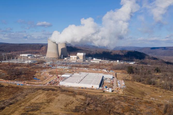 A data center owned by Amazon Web Services, front right, is under construction next to the Susquehanna nuclear power plant in Berwick, Pa., on Tuesday, Jan. 14, 2024. A data center owned by Amazon Web Services, front right, is under construction next to the Susquehanna nuclear power plant in Berwick, Pa., on Tuesday, Jan. 14, 2024.