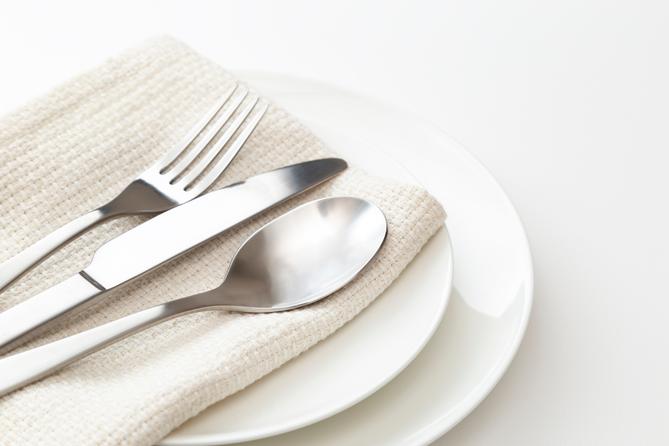 A stock image of a plate, silverware, and napkin. A stock image of a plate, silverware, and napkin.