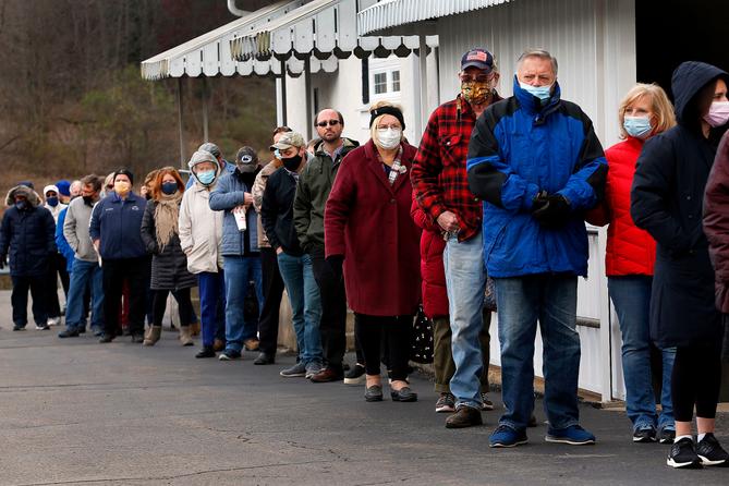 Voters stand in a line that kept growing in Jackson Township with a wait time of over an hour or more to voteat the Jackson Township Volunteer Fire House    FRED ADAMS/For the Inquirer 11-3-2020