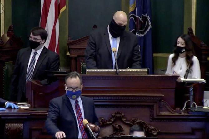 Lt. Gov. John Fetterman (center) confers with Senate Secretary Megan Martin (right), as Sen. Jake Corman (front, center), takes over the session to conduct a vote to remove Fetterman from residing over the session in Harrisburg on Tuesday, Jan. 5, 2021. Bobby Maggio, Fetterman’s chief of staff, stands to the left.