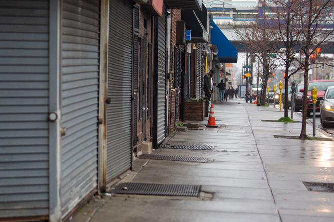 A man standing on the sidewalk on 52nd Street is surrounded by local business’s that are closed due to the coronavirus outbreak on Saturday, March, 28, 2020.