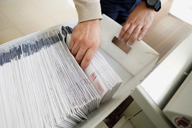 Mail-in ballots are sorted and counted by workers on Election Day in Northampton County. 